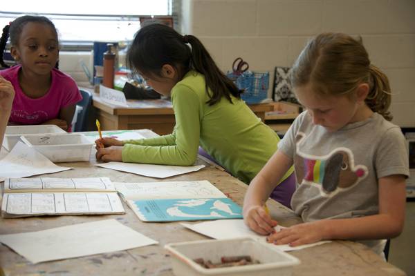 Children engaged in a hands-on educational assessment or collaborative learning activity in a classroom setting