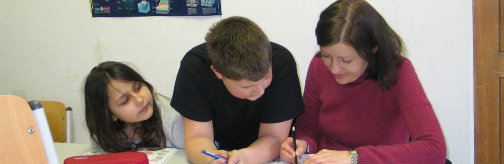 A group of diverse children working together on educational games and puzzles