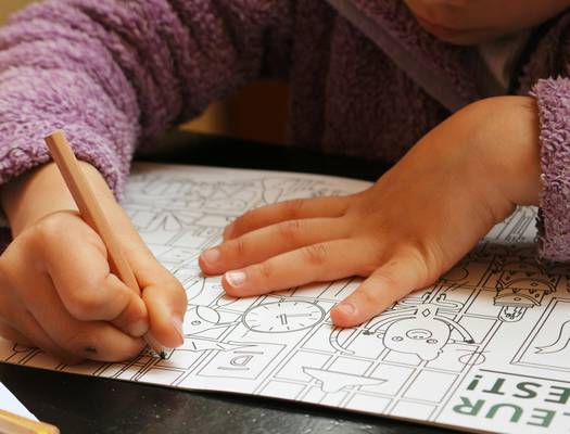 Illustration of children happily engaging with logic puzzles, brainteasers and visual challenges, representing playful learning